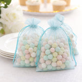 Pastel candy-filled organza bags for party favors.