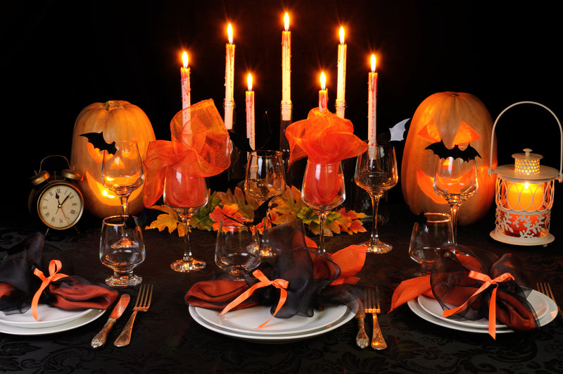 Halloween tablescape with candles and jack-o'-lanterns