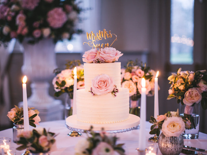 Two-tier pink wedding cake with roses