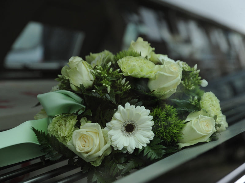 White floral bouquet on a car windshield