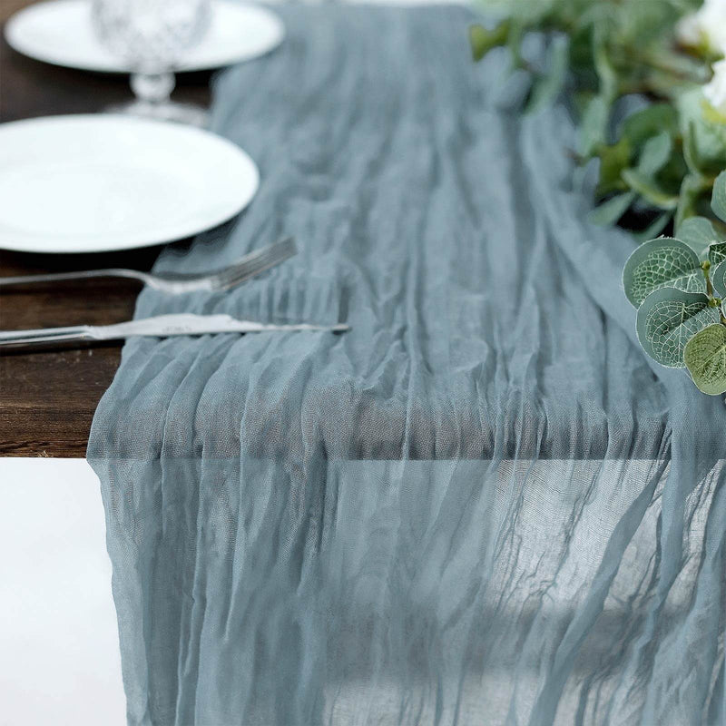 Dusty blue gauze table runner on a dining table