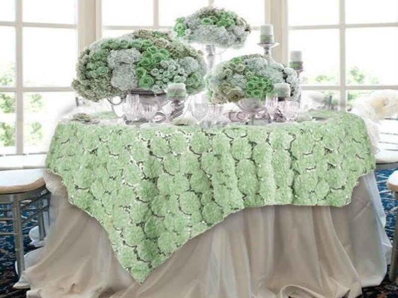 Green floral centerpiece on a draped table