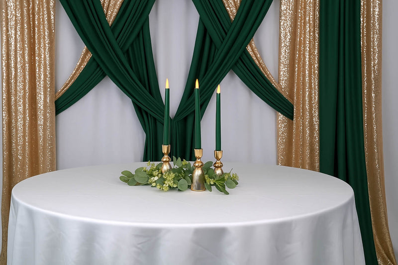 Candle centerpiece adds height to luxurious green and gold table decor.