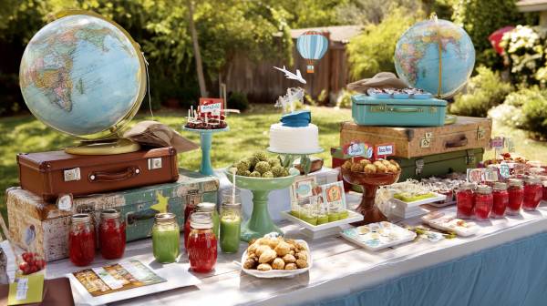 Graduation party table with globe-themed decorations and desserts