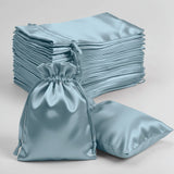 Blue satin drawstring bags on a white background.