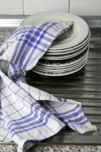 Dish stack wrapped in a plaid tablecloth