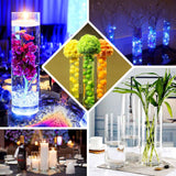 Decorative vases with flowers and lights for elegant table settings.