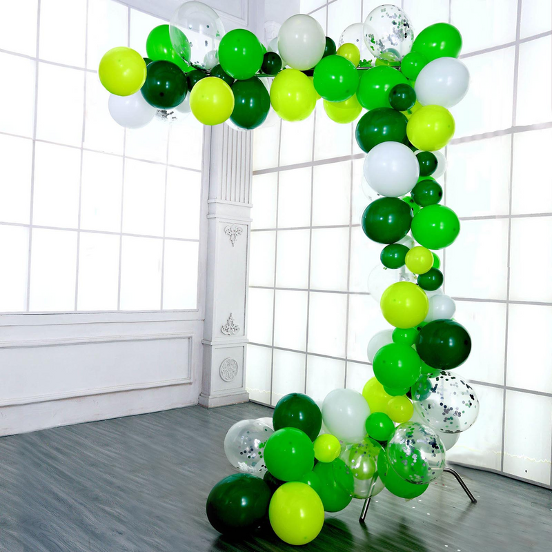 Green and white balloon arch in an event room