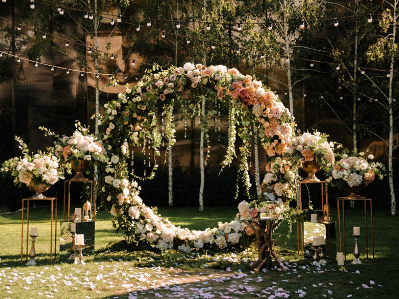 Floral circular wedding arch in a garden