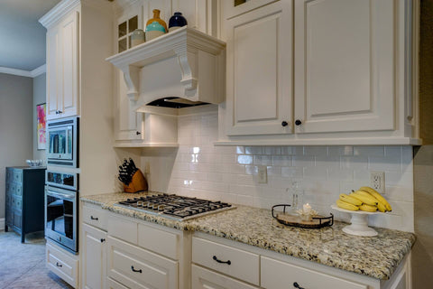 Kitchen countertop with white cabinets and a fruit bowl