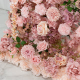 Pink artificial flower arrangement on a marble surface. 