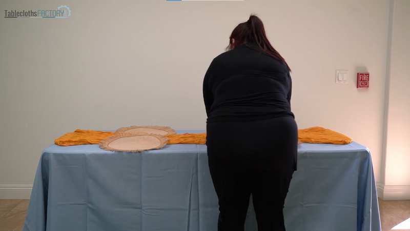 Person setting up the table linens