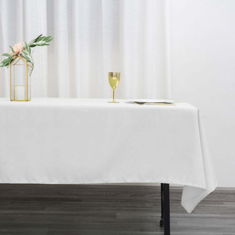 White tablecloth with gold vase and glass goblet