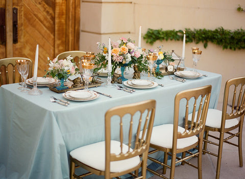 Blue table setting with floral centerpiece