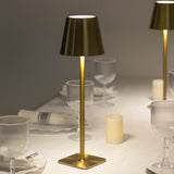Elegant gold table lamp with a cone-shaped shade and soft glow, perfect for dining settings.
