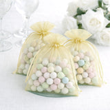Pastel candy-filled favor bags in sheer yellow pouches.
