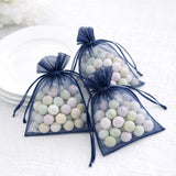 Navy organza bags filled with pastel-colored candies