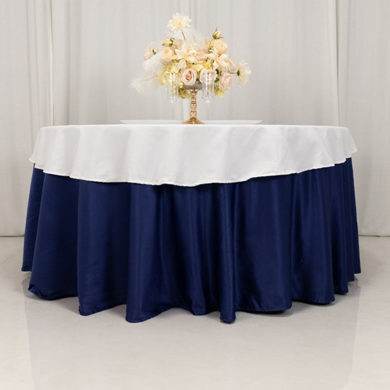 Navy table skirt with white tablecloth overlay