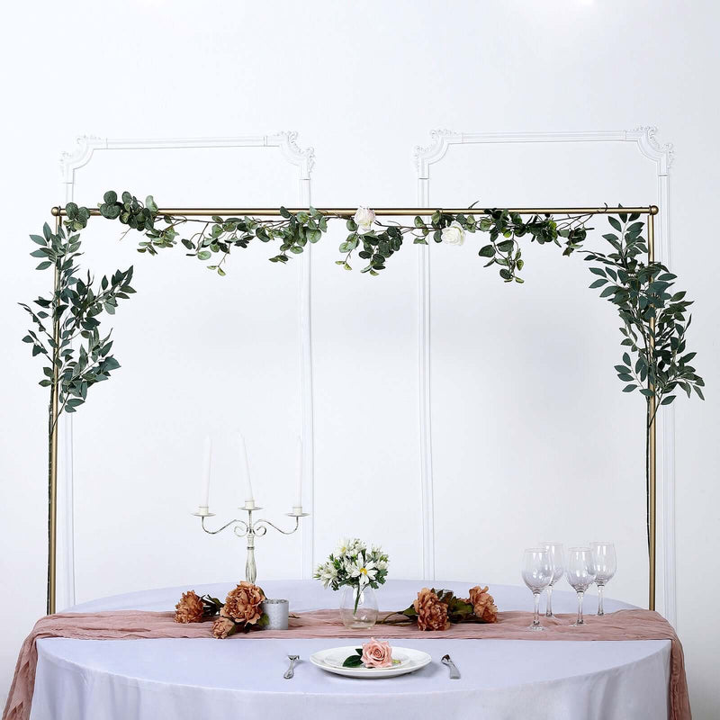 Gold backdrop frame with greenery garland