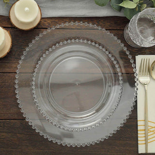 Clear decorative charger plate with beaded edge on wooden table setting.