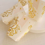 Gold floral thank you gift boxes on a table setting.