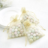 Pastel candy-filled organza bags arranged on a table