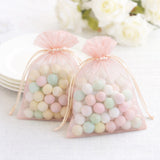 Pastel candy-filled organza bags tied with ribbons.