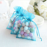 Colorful decorative balls in sheer blue gift bags for party favors.