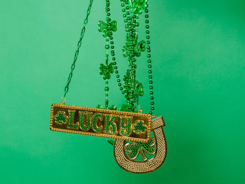 Lucky pendant necklace on a green background