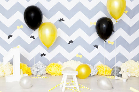 Chevron backdrop with black and gold balloons