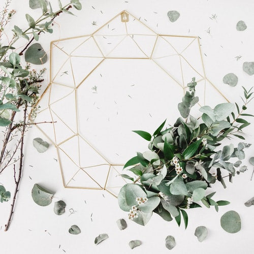 Geometric gold frame with eucalyptus arrangement
