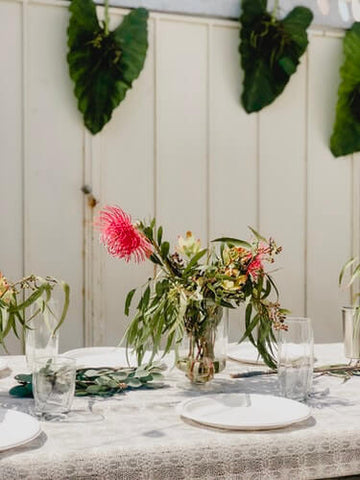Gold polka dot tablecloth with glass of mint water