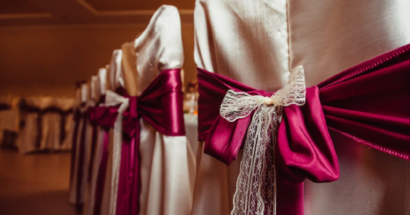 Fuchsia satin chair sash tied in a bow
