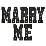 Marquee letters spelling “MARRY ME” with lights on white background#whtbkgd