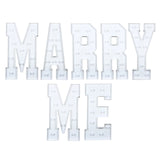 White marquee letters spelling “MARRY ME” on a white background.#whtbkgd