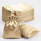 Gold satin drawstring bags with matching pillowcases, ideal for elegant storage.