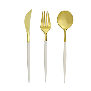 Gold-plated cutlery set with white handles: knife, fork, and spoon.