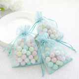 Pastel candy-filled organza bags for events and celebrations.