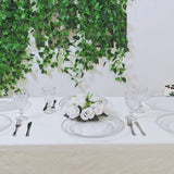 Clear round plastic charger plates with silver beaded rim on a dining table.
