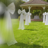 Giant white bow tie décor for wedding and event photo booth backdrop.