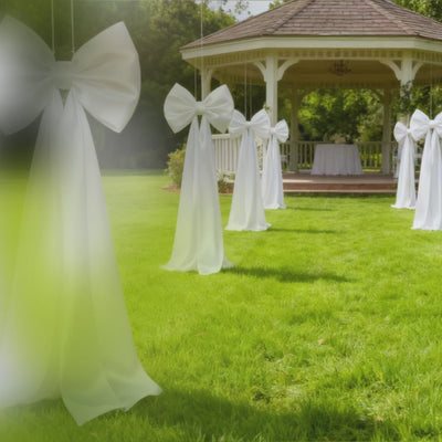 Giant white bow tie décor for wedding and event photo booth backdrop.