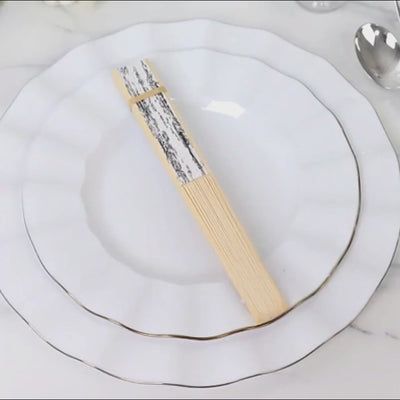 White and black French toile pattern handheld fans with bamboo frame.