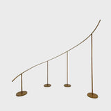 Gold curved wave wedding arch backdrop stand for balloon and floral décor.