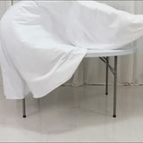 White fire retardant scuba tablecloth on a round table, wrinkle-free and seamless.