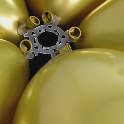Clear flower-shaped balloon clip connectors in gold for party decorations.