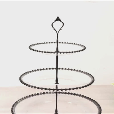 Clear 3-tier plastic dessert display stand with black beaded rim.