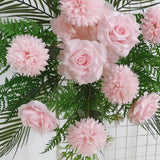 Blush pink artificial wedding arch flowers with greenery and palm leaves.