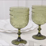 Dusty sage green vintage plastic wine goblets with embossed floral pattern.