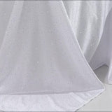 White rectangular tablecloth with rhinestone accents, seamless and wrinkle-free.