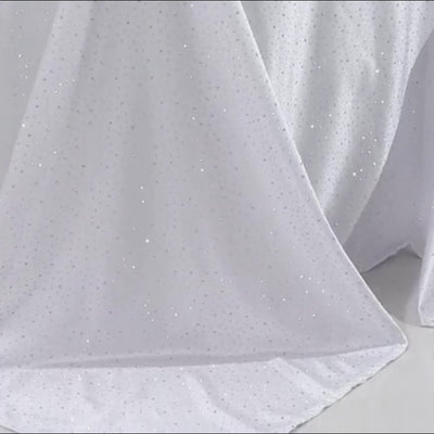 White rectangular tablecloth with rhinestone accents, seamless and wrinkle-free.